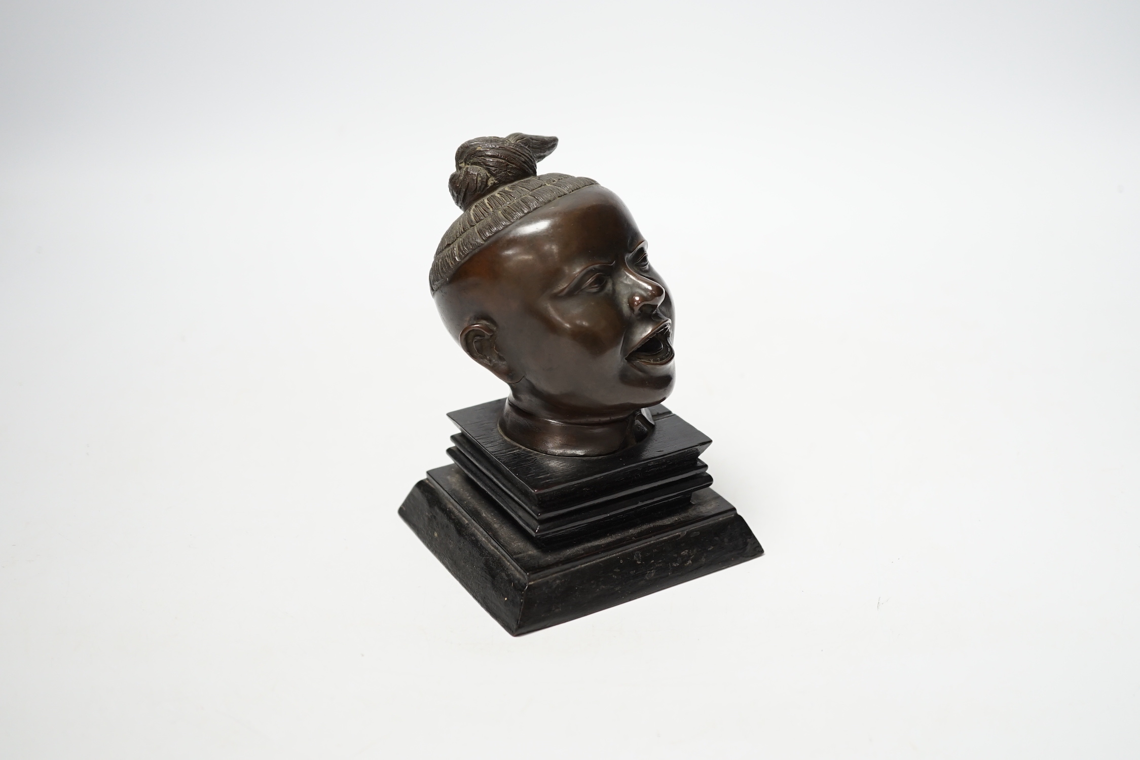 A Malaysian bronze head of a boy, 12.5cm high